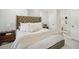 Comfortable bedroom features a plush bed, neutral tones, and access to the bathroom at 4335 S Coolidge Ave, Tampa, FL 33611