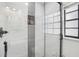 Modern shower features sleek tiling, glass door, and built-in storage niche at 4335 S Coolidge Ave, Tampa, FL 33611