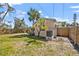Well-maintained backyard with new fence and mature trees, providing plenty of shade at 437 79Th Ave, St Pete Beach, FL 33706