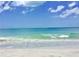 Beautiful view of the beach with clear water and a boat on the horizon, a peaceful setting for relaxation and recreation at 437 79Th Ave, St Pete Beach, FL 33706
