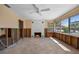 Bright living room featuring a fireplace, ceiling fan, and large windows at 437 79Th Ave, St Pete Beach, FL 33706