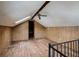 Spacious attic area with wood-paneled walls, skylight, ceiling fan, and railing at 8226 36Th N Ave, St Petersburg, FL 33710