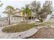 View of home with a small enclosed porch, slide, and a mature tree at 8226 36Th N Ave, St Petersburg, FL 33710