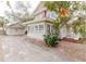 Side view of a two-story house with a detached garage and a concrete driveway at 8226 36Th N Ave, St Petersburg, FL 33710