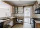 Incomplete kitchen with outdated appliances, countertops, cabinetry, and tile backsplash at 8226 36Th N Ave, St Petersburg, FL 33710