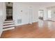 Open-concept living area with hardwood floors, stairs, and natural light from many windows at 8226 36Th N Ave, St Petersburg, FL 33710