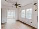 Bright living room features large windows, ceiling fan, and hardwood floors, with a neutral color palette at 8226 36Th N Ave, St Petersburg, FL 33710