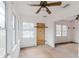 Sunroom filled with natural light from multiple windows, ceiling fan, and hardwood flooring at 8226 36Th N Ave, St Petersburg, FL 33710