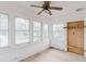 Sunroom filled with natural light from multiple windows, ceiling fan, and hardwood flooring at 8226 36Th N Ave, St Petersburg, FL 33710