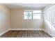 Bedroom featuring wood floors, neutral walls, a closet and a window for natural light at 1338 Windsor Way, Tampa, FL 33619