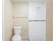 Clean bathroom offering a tile shower with a decorative accent, a toilet, and neutral wall color at 3720 E Idlewild Ave, Tampa, FL 33610