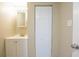 Neat bathroom featuring a single sink vanity, a well-lit mirror, and a closet for storage convenience at 3720 E Idlewild Ave, Tampa, FL 33610