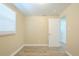 Bright bedroom featuring wood-look floors, a large window, and a freshly painted door for a modern look at 3720 E Idlewild Ave, Tampa, FL 33610