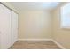 Bright bedroom featuring wood-look floors, a large closet, and natural light from the window at 3720 E Idlewild Ave, Tampa, FL 33610