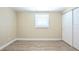 Bright bedroom features wood-look floors, a window with blinds, and a closet for storage at 3720 E Idlewild Ave, Tampa, FL 33610