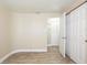 Bright bedroom features wood-look flooring, fresh paint, and sliding closet doors at 3720 E Idlewild Ave, Tampa, FL 33610