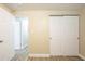 Hallway offering wood-look floors, white baseboards, and multiple doors creating a sense of flow and connectivity at 3720 E Idlewild Ave, Tampa, FL 33610