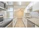 Beautiful updated kitchen with stainless steel appliances and white cabinetry at 3720 E Idlewild Ave, Tampa, FL 33610