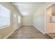 Bright living room featuring wood-look floors and fresh, neutral paint at 3720 E Idlewild Ave, Tampa, FL 33610