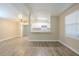Bright living room showcasing wood-look flooring that flows into the open kitchen and dining areas at 3720 E Idlewild Ave, Tampa, FL 33610