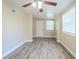 This open room features a ceiling fan and windows, perfect for comfortable living and relaxation at 3720 E Idlewild Ave, Tampa, FL 33610