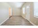 Open living area with neutral walls and stylish wood-look floors throughout at 3720 E Idlewild Ave, Tampa, FL 33610
