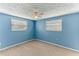 This bedroom features two windows and light blue walls at 4046 Las Vegas Dr, New Port Richey, FL 34653