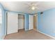 Bedroom featuring a ceiling fan, closet, and an open doorway to another room at 4046 Las Vegas Dr, New Port Richey, FL 34653