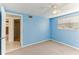 Serene bedroom with blue walls, neutral carpet, and a ceiling fan at 4046 Las Vegas Dr, New Port Richey, FL 34653