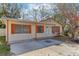 Charming home featuring a covered porch, decorative shutters, and a well-manicured yard at 4046 Las Vegas Dr, New Port Richey, FL 34653