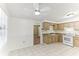 Bright kitchen with ample counter space, white appliances, and a view to the carpeted room at 4046 Las Vegas Dr, New Port Richey, FL 34653