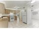 Well-lit kitchen with updated appliances and light-colored cabinetry, next to the living room at 4046 Las Vegas Dr, New Port Richey, FL 34653