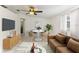 Bright living room featuring a ceiling fan, lots of natural light, and a small dining area near the window at 4046 Las Vegas Dr, New Port Richey, FL 34653
