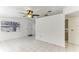 Spacious living room with tile floors, a ceiling fan, and ample light from a window and front door at 4046 Las Vegas Dr, New Port Richey, FL 34653