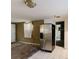 Kitchen area with a stainless steel refrigerator, tile floor, and view into another room at 1825 134Th St, Largo, FL 33778