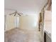 Spacious living room with ceiling fan, large windows and doorway entrance offering ample natural light and potential for design at 1825 134Th St, Largo, FL 33778