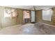 Living room with a ceiling fan, window and doorway, offering potential for renovation and natural light at 1825 134Th St, Largo, FL 33778