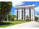 The exterior of a condominium complex with palm trees and beautiful landscaping at 2109 Bayshore Blvd # 103, Tampa, FL 33606