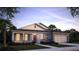 Beautiful single story home featuring stone accents, shutters, a two car garage and a landscaped yard at 2994 Alesio Ave, North Port, FL 34286