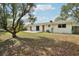 Exterior back view of home featuring large backyard and patio at 4594 Essex Ln, Spring Hill, FL 34606