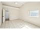 Bright bedroom with white ceiling fan, tiled floors and door to outside at 4594 Essex Ln, Spring Hill, FL 34606