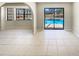 Living room with tiled floors, arched doorways, and a view of the pool at 7281 Jasbow Jct, Weeki Wachee, FL 34613