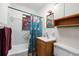 Classic bathroom featuring a tub, shower, vanity, and charming nautical-themed decor at 8608 N 20Th St, Tampa, FL 33604