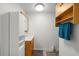 Well-lit bathroom with a modern sink, vanity, and ample storage cabinets at 8608 N 20Th St, Tampa, FL 33604