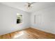 Bright bedroom showcasing hardwood floors, natural light, and a ceiling fan at 8608 N 20Th St, Tampa, FL 33604