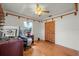 Comfortable bedroom with natural light and hardwood floors, complemented by a ceiling fan at 8608 N 20Th St, Tampa, FL 33604