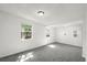 Neutral bedroom with carpet, multiple windows, and modern lighting fixtures at 8608 N 20Th St, Tampa, FL 33604