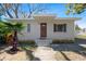 Charming single-story home with a well-maintained lawn, a tidy flower bed, and a quaint front porch at 8608 N 20Th St, Tampa, FL 33604