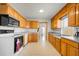 Functional kitchen with wood cabinets, modern appliances, and plenty of counter space for meal preparation at 8608 N 20Th St, Tampa, FL 33604