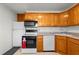 Well-equipped kitchen featuring wood cabinetry, white appliances, and ample counter space at 8608 N 20Th St, Tampa, FL 33604
